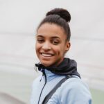 smiling fit young african sportswoman carrying spo 2021 08 27 18 29 01 utc